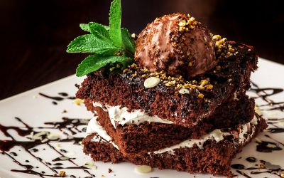 Chocolate brownie cake with a scoop of ice cream.